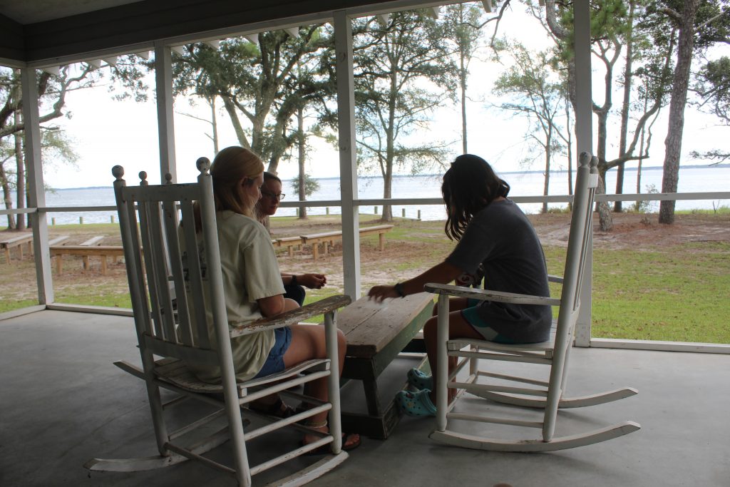 Playing cards on the porch of Jack & Gladys Lee cabin