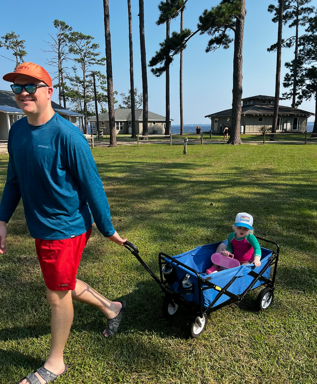 Screenshot 2025-09-16 at 4.36.27 PM Dad Alex pulling daughter Adair at Family Camp