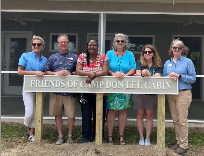 Screenshot 2025-10-16 at 2.35.28 PM Board Members outside new Friends of Camp Don Lee Cabin